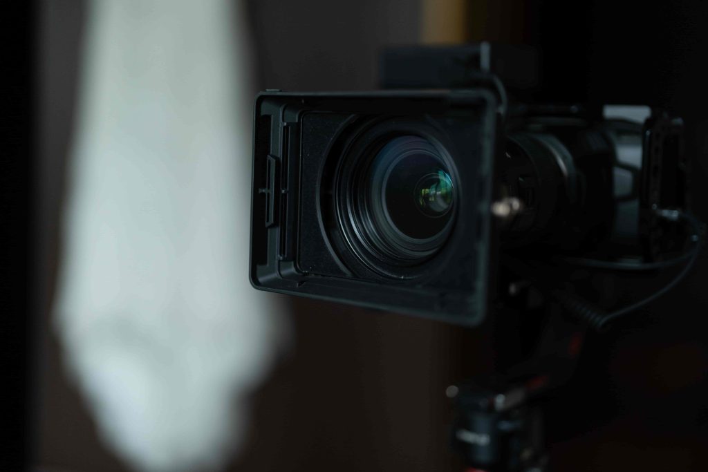 A high-end film production by a Chicago Video Production Company capturing a luxury penthouse interior with views of the Willis Tower and the Chicago River.