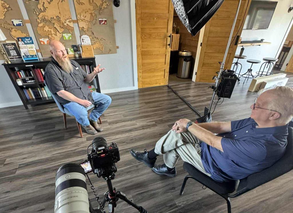An elite New Orleans video production company team led by Benjamin Tone reviewing a high-velocity video brief for a historic shoot.