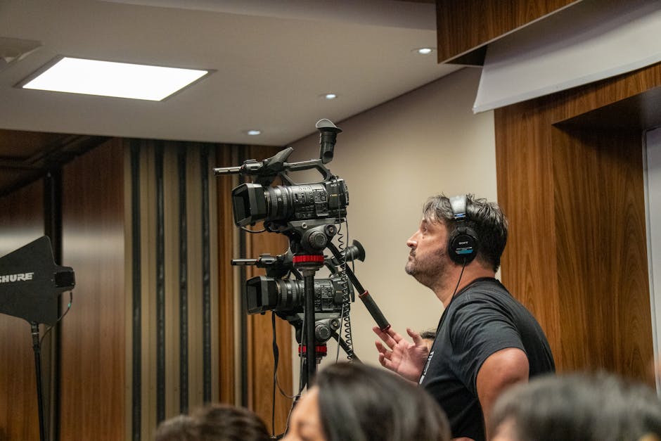 Benjamin Tone of Tone Production reviewing a Southeast Texas Commercial Authority cinematic video production commercial brief with a Golden Triangle brand client in Beaumont TX — 8K RAW cinema camera equipment, DaVinci Resolve color grading workstation, and multi-format delivery documentation visible at a Beaumont Texas cinematic brand video production company engagement for ExxonMobil supplier qualification or Baptist Hospitals physician recruitment in 2026
