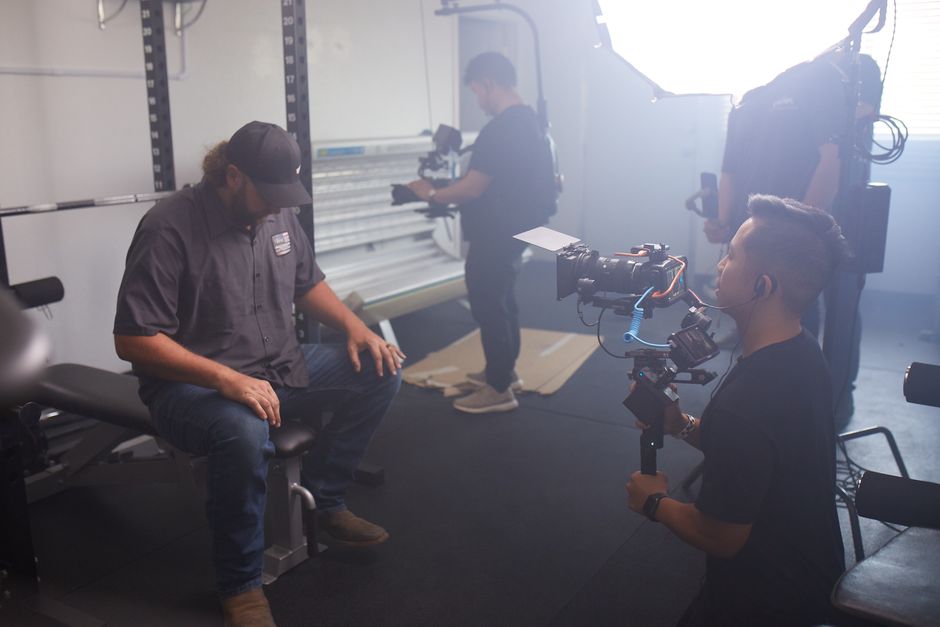 Cinematographer from an Orlando video production company setting up a cinema camera for a corporate brand video shoot