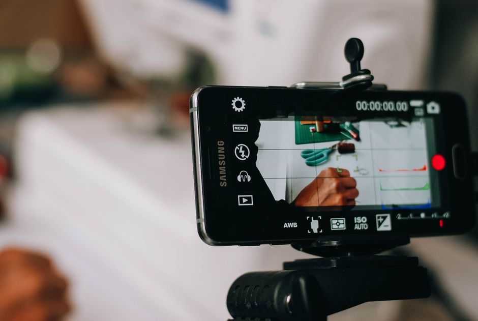 Creator filming UGC-style ads that convert on a smartphone in natural light