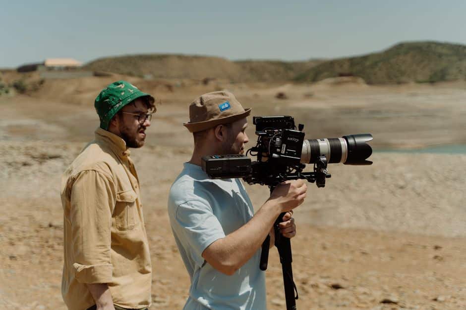 Videographer offloading and organizing footage on a laptop during a professional video production shoot