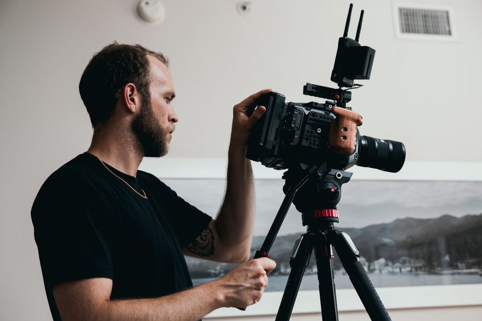 Beginner videographer reviewing camera settings — a beginner's guide to videography in practice