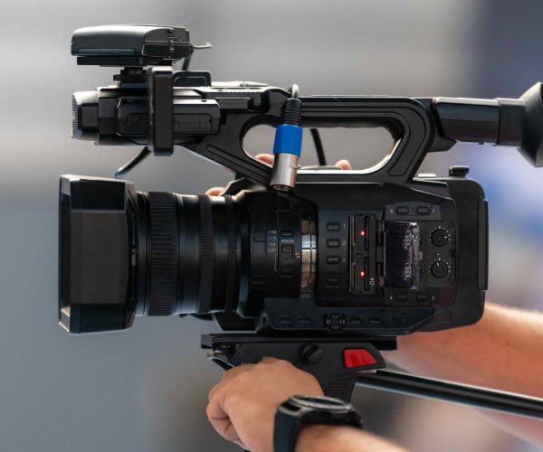 A high-end Auburn Video Production Company film crew from Tone Production capturing a cinematic brand story on a vibrant Auburn campus.