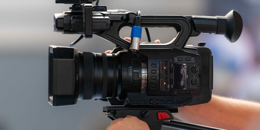 A high-end Auburn Video Production Company film crew from Tone Production capturing a cinematic brand story on a vibrant Auburn campus.