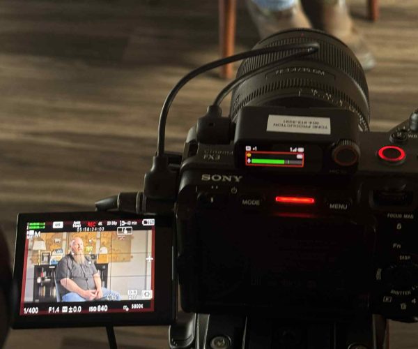 A professional Chicago Video Production Company filming a high-end client testimonial in a downtown office.