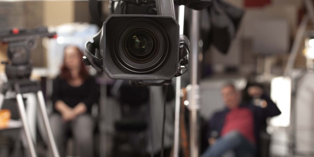 A professional Covington Video Production Company team from Tone Production filming high-energy social media content on location.