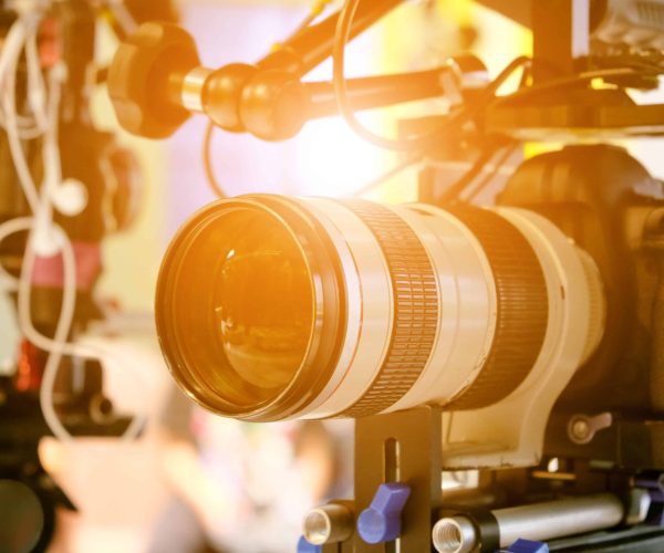 A professional film crew from a Houston Video Production Agency filming a high-level B2B corporate interview in a modern downtown office.