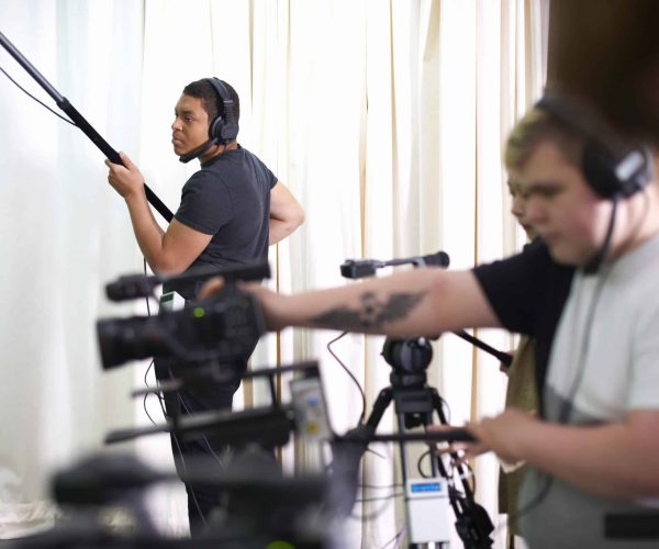 College students filming and recording in TV studio