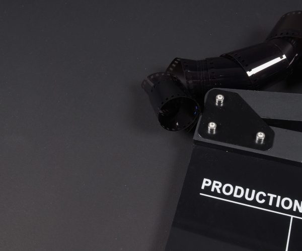 Clapperboard or clap board or movie slate with film use in video production, cinema industry on black background.