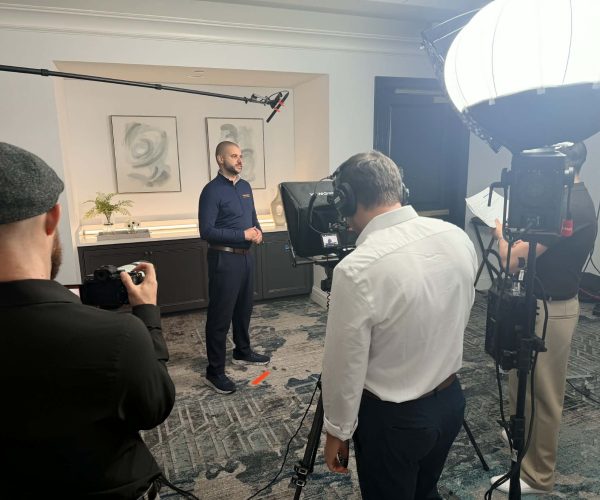 A professional Corporate Video Production in Chicago team from Tone Production capturing a high-end executive interview with the Chicago skyline in the background.