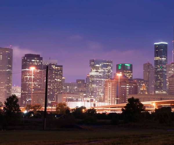 A professional film crew from a Houston Video Production Agency capturing high-end corporate content in a modern Houston skyscraper.