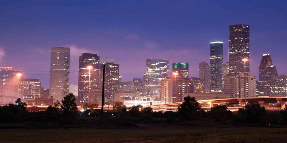A professional film crew from a Houston Video Production Agency capturing high-end corporate content in a modern Houston skyscraper.