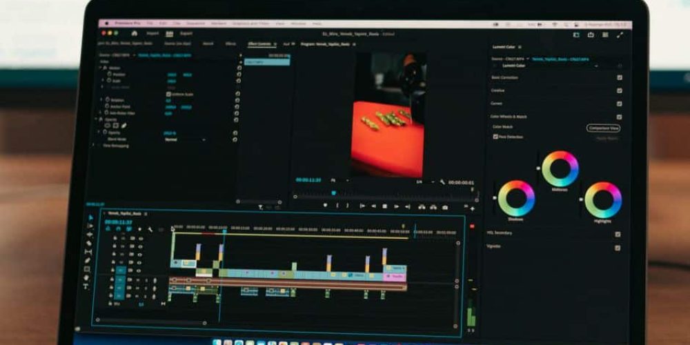 Marketer reviewing AI video tools for marketers on a laptop screen in a modern office