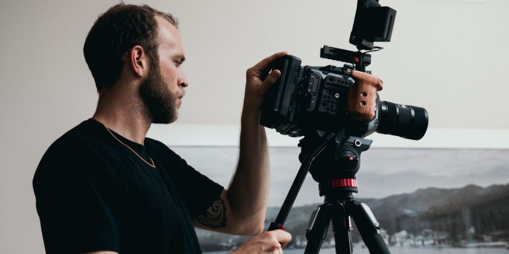 Beginner videographer reviewing camera settings — a beginner's guide to videography in practice