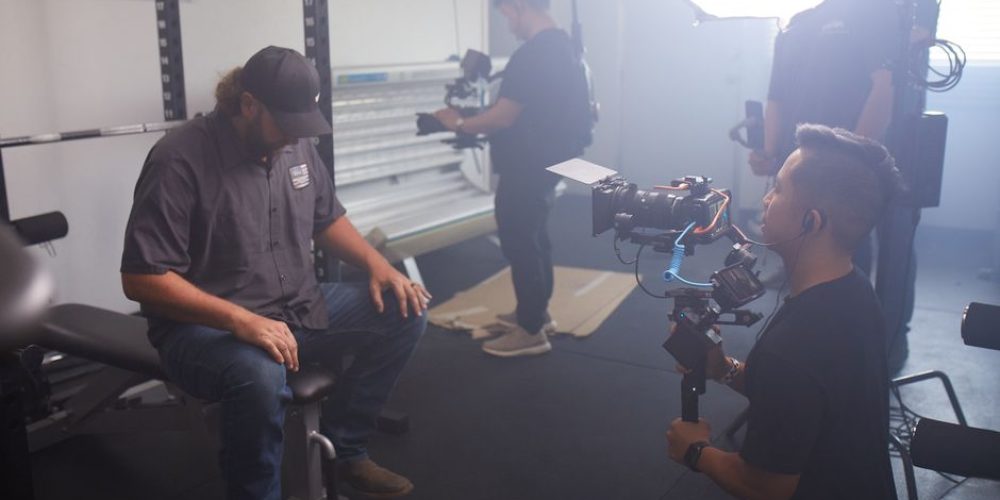 Cinematographer from an Orlando video production company setting up a cinema camera for a corporate brand video shoot