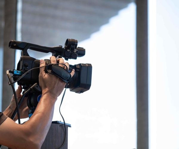 person-operating-professional-video-camera-indoors-2026-01-06-00-49-49-utc-2