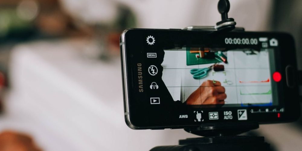 Creator filming UGC-style ads that convert on a smartphone in natural light