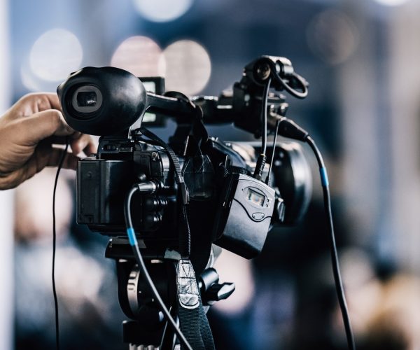 Camera recording at a press conference. Live streaming.